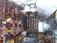 From this picture of the same bay, but this time on the forward bulkhead of it, you can see that the craft's systems operate on AC 3-Phase power, that is the red, yellow and blue 'channels' seen. Each of the APUs generate electricity for the craft via integrated drive generators (IDG) and constant speed drives (CSD), similar to the systems found on most jet aircraft. <br><br>The power generated from these IDGs was then fed, via isolator switches controlled from the cockpit, into the main high voltage AC busbar, and from there via transformer rectifier units (TRU) onto the low voltage DC busbar. The AC busbar is used to power the flight control instruments, hydraulic actuators, and the loading doors/ramps. The DC busbar provides power for domestic systems such as lighting, radio and intercom. <br><br>I'm not sure as to the operating frequencies and voltages of the electronics system but they will probably be in the range of 415v (AC) at 200Hz and 30v (DC).